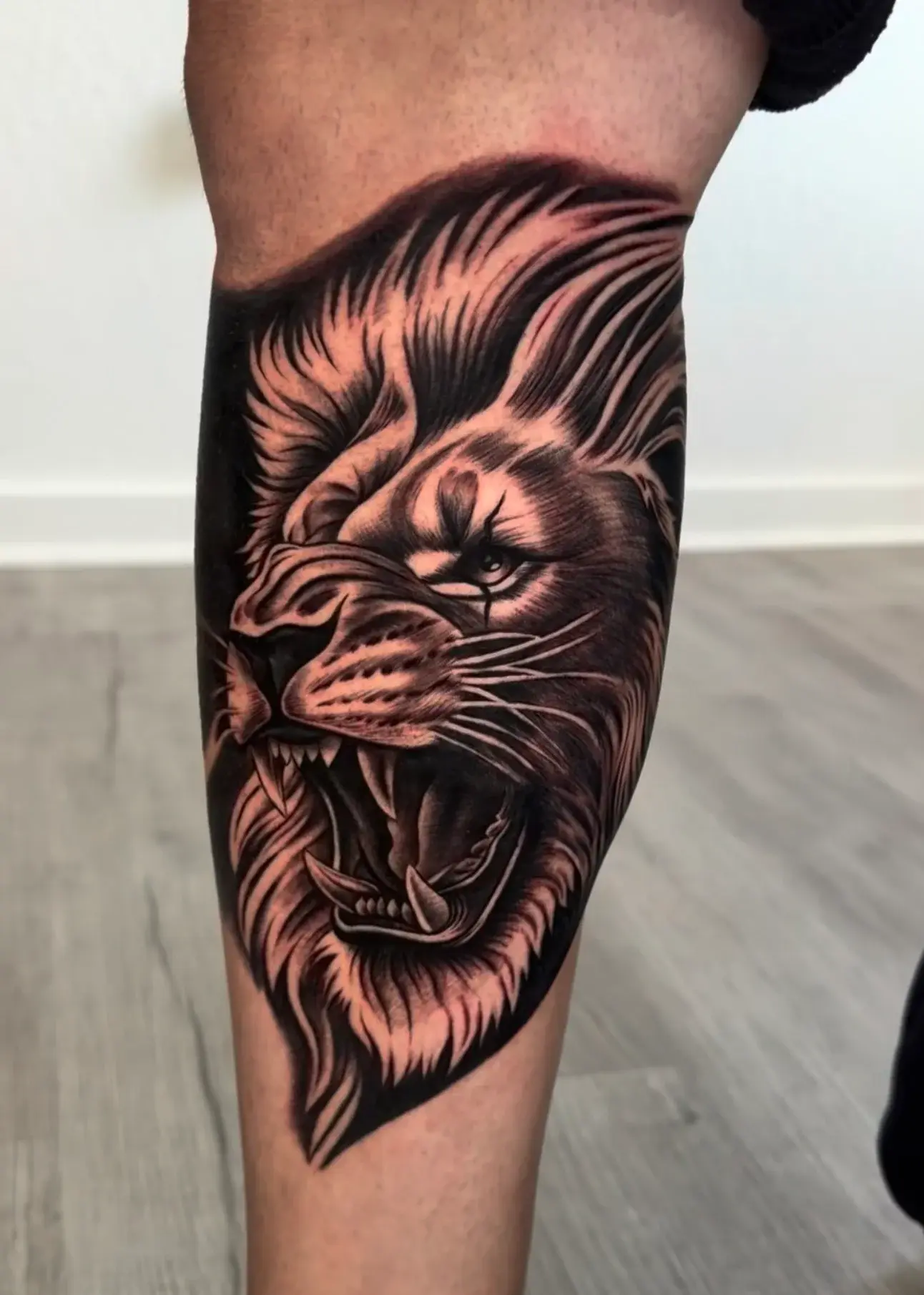 Black and gray roaring lion tattoo by Marcos