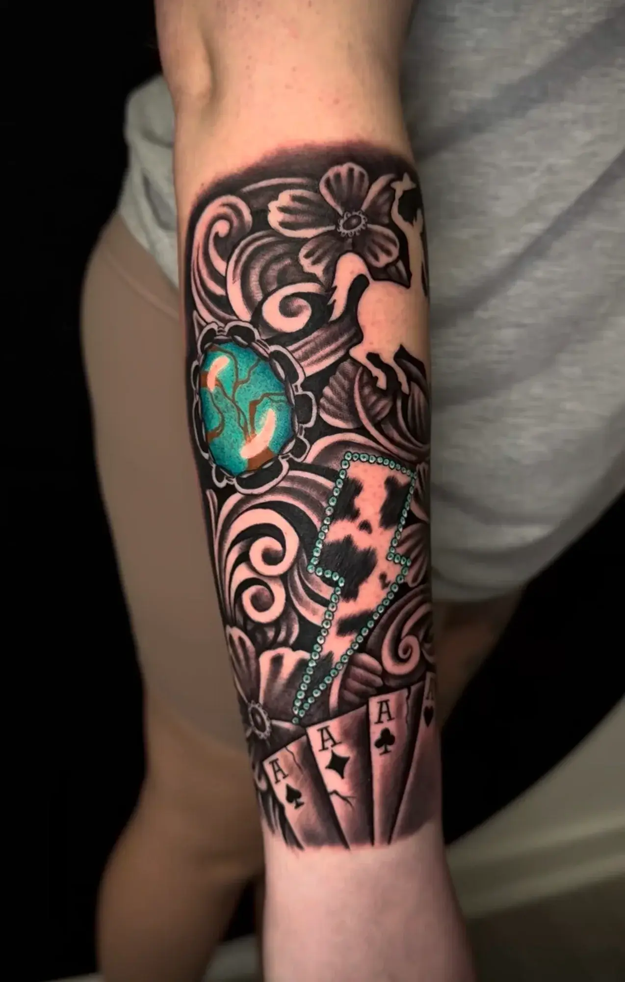Turquoise stone, lightning bolt, and playing cards tattoo by Marcos