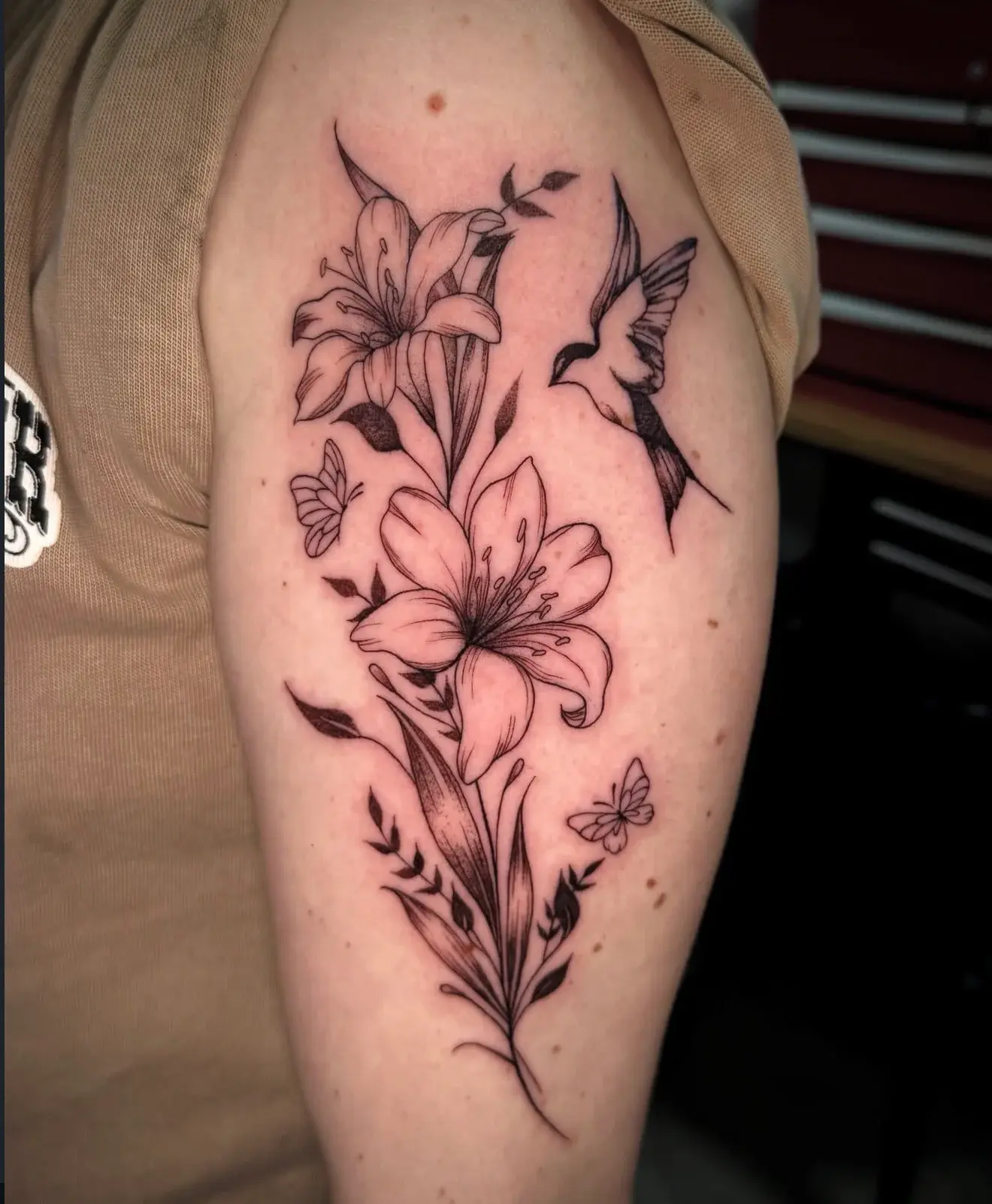 Hummingbird, lilies, and butterflies tattoo by Lucia